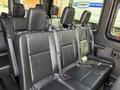 The interior of a 2019 Mercedes-Benz Sprinter featuring black leather seats with seat belts in a row configuration