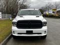 A white 2022 RAM 1500 Classic with a black grille and hood vents is parked facing the viewer
