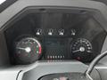 Dashboard of a 2013 Ford F-650 displaying speedometer tachometer fuel and temperature gauges along with a digital screen showing odometer reading