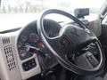 Interior of a 2012 International 7300 truck showing the steering wheel dashboard and control panel with various gauges and buttons