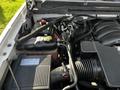 The engine compartment of a 2017 GMC Sierra 1500 showcasing the engine components including the air intake and coolant reservoir