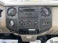Dashboard of a 2008 Ford F-550 with various controls for temperature music and power settings