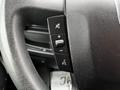 Close-up of the steering wheel controls of a 2018 RAM Promaster featuring a volume button and a mute button
