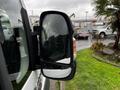 Close-up of the side mirror of a 2016 RAM Promaster with raindrops on the glass