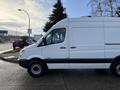 A 2012 Mercedes-Benz Sprinter van in white parked with its side visible and a black stripe along the bottom edge