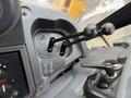 Interior control panel of a 2011 John Deere 310SJ 4x4 Wheel Loader featuring dual levers and various gauges for operation