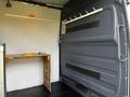 A 2017 Mercedes-Benz Sprinter van interior featuring a wooden table and wall-mounted hooks on the side panel