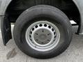 Close-up of a wheel from a 2012 Mercedes-Benz Sprinter showing a silver rim with circular holes and a black tire with visible tread pattern