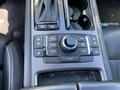 The center console of a 2017 Genesis G80 featuring a control knob surrounded by buttons for navigation phone and audio functions