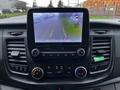 Interior view of a 2021 Ford Transit dashboard featuring a touchscreen display with a rearview camera interface and control knobs for audio and climate settings