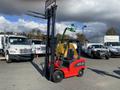 A red 2024 AGT KFE20 forklift with an upright lifting mechanism and forks positioned in the air