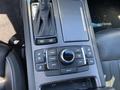 The image shows the center console of a 2017 Genesis G80 featuring a gear shifter and various control buttons for navigation media and vehicle settings