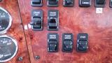 Dashboard controls of a 2003 International 5600i featuring switches for cruise control heated mirror power mirror and ether