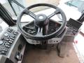 The interior view of a 2015 Global Street Sweeper showing the steering wheel control panel and various dashboard controls
