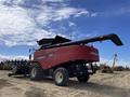 A red 2014 Versatile RT490 combine harvester with a raised grain tank and large wheels parked on a dirt field