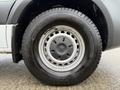 A close-up of a wheel on a 2019 Mercedes-Benz Sprinter featuring a silver rim and a textured black tire with the brand name visible
