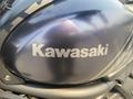 Close-up of a 2020 Kawasaki Vulcan S motorcycle engine cover featuring the Kawasaki logo in a sleek design