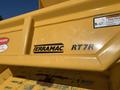 A close-up view of a yellow TerraMac RT7R tracked dump with branding prominently displayed on its side